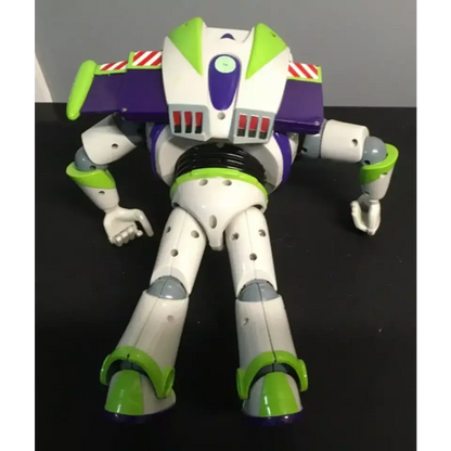 Rear view of a Buzz Lightyear action figure lying face down, showing the battery compartment