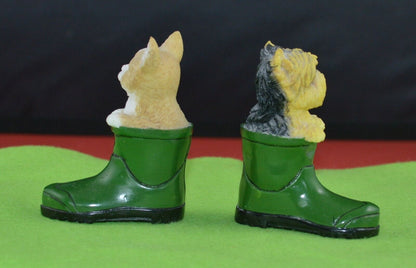 These previously owned figurines of a dog and a cat in a green wellington boot