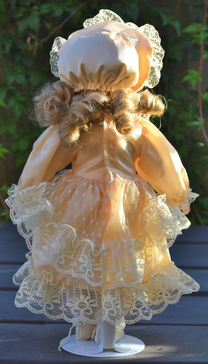 PORCELAIN DOLL IN A LIGHT PEACH DRESS - TMD167207