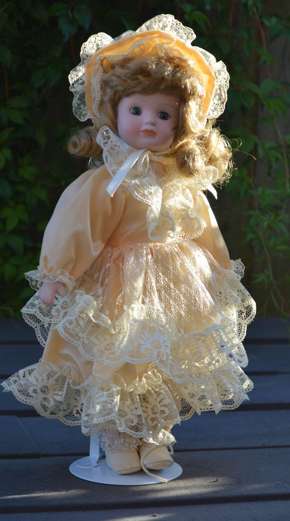 PORCELAIN DOLL IN A LIGHT PEACH DRESS - TMD167207