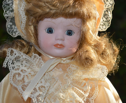 PORCELAIN DOLL IN A LIGHT PEACH DRESS - TMD167207