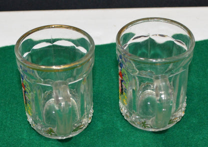 TWO MINIATURE GLASS TANKARDS DEPICTING THE TRADITIONAL COSTUME OF A WELSH LADY(PREVIOUSLY OWNED) GOOD CONDITION - TMD167207