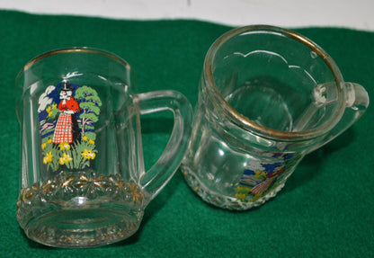 TWO MINIATURE GLASS TANKARDS DEPICTING THE TRADITIONAL COSTUME OF A WELSH LADY(PREVIOUSLY OWNED) GOOD CONDITION - TMD167207