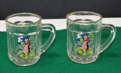 TWO MINIATURE GLASS TANKARDS DEPICTING THE TRADITIONAL COSTUME OF A WELSH LADY(PREVIOUSLY OWNED) GOOD CONDITION - TMD167207