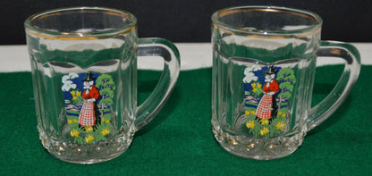 TWO MINIATURE GLASS TANKARDS DEPICTING THE TRADITIONAL COSTUME OF A WELSH LADY(PREVIOUSLY OWNED) GOOD CONDITION - TMD167207